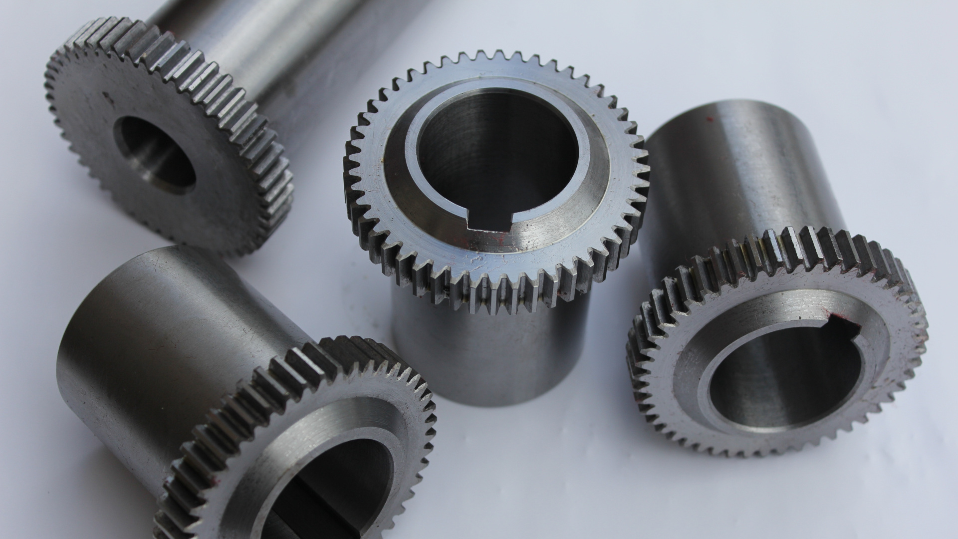 Machined gears displayed on a desk, showcasing the precision and quality of the machining process.
